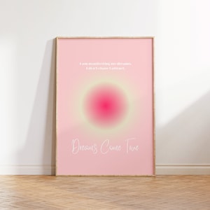 May include: Pink and yellow gradient background with a white circle in the center. The text "I am manifesting my dreams. I don't chase I attract." is at the top of the image. The text "Dreams Come True" is at the bottom of the image.
