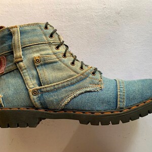 May include: Blue denim boots with a lace-up closure and a black rubber sole.