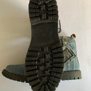May include: Blue denim boots with black laces and a black rubber sole. The boots have a distressed look and the text "Brave Soul" and "Size 8 Skanders" is visible on the side.