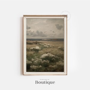 May include: A framed print of a landscape painting depicting a field of white wildflowers in the foreground with a body of water and a cloudy sky in the background.