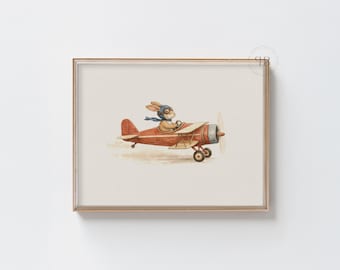 May include: A framed watercolor print featuring a bunny wearing a pilot's cap and scarf, flying a vintage red airplane. The artwork has a whimsical, vintage aesthetic, perfect for children's room decor.