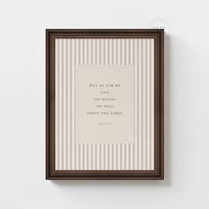 May include: A framed print with a dark brown wooden frame. The print features a beige background with vertical stripes and a central rectangular area with text that reads, "But as for me and my house we will serve the Lord."