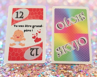 Anuncio original de embarazo/buenas noticias en tarjeta SKYJO, la famosa +4 o la clásica 52. Hecho con naipes auténticos.