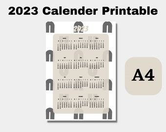 Puede incluir: Calendario imprimible 2023 en blanco y negro con fondo beige. El calendario presenta un patrón repetitivo de arcos negros y blancos. El calendario está etiquetado como "2023" e incluye los 12 meses del año. El tamaño del calendario es A4.
