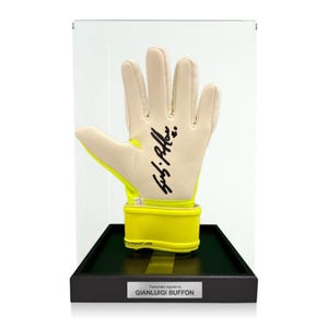 May include: A goalkeeper glove with a beige palm and neon yellow accents, featuring a black signature on the palm. The glove is displayed inside a clear acrylic case on a black base with a silver plaque reading Personally signed by GIANLUIGI BUFFON.
