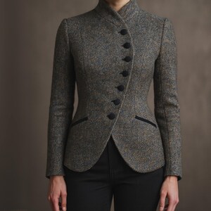 May include: A tailored tweed jacket in shades of gray, brown, and blue. The jacket features a high collar, a series of black buttons, and black trim on the pockets. The jacket is worn with black pants.