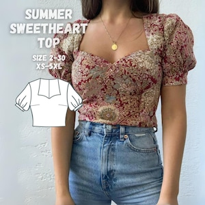 May include: A red and gold floral print top with a sweetheart neckline and short puff sleeves. The top is cropped and has a fitted silhouette. The model is wearing the top with high-waisted blue jeans. The text "SUMMER SWEETHEART TOP" and "SIZE 2-30 XS-5XL" is displayed on the image.