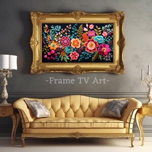 May include: A framed embroidery artwork featuring a colourful floral bouquet with pink, red, orange, yellow, and blue flowers on a black background. The frame is gold with ornate detailing.