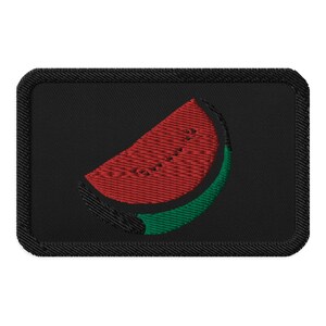 May include: A black embroidered patch with a red watermelon slice on a green rind.