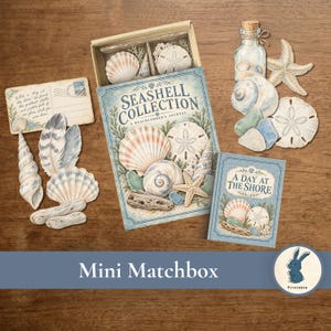 May include: A Seashell Collection matchbox set featuring a journal, a postcard with handwritten text, and various paper cutouts of seashells, starfish, sea glass, feathers, and a message in a bottle. The set includes a small book titled A Day at the Shore.