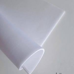 May include: A close-up of a white fabric, folded in half, with the word "white" printed below it.