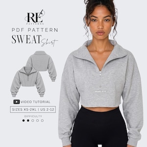 Puede incluir: Una sudadera corta de color gris claro con cuello de cremallera, mangas largas con puños acanalados y cuerpo estructurado. El texto RE PATTERNS PDF PATTERN SWEATSHIRT, VIDEO TUTORIAL, SIZES XS-2XL | US 2-12 y REBEL EYE es visible.