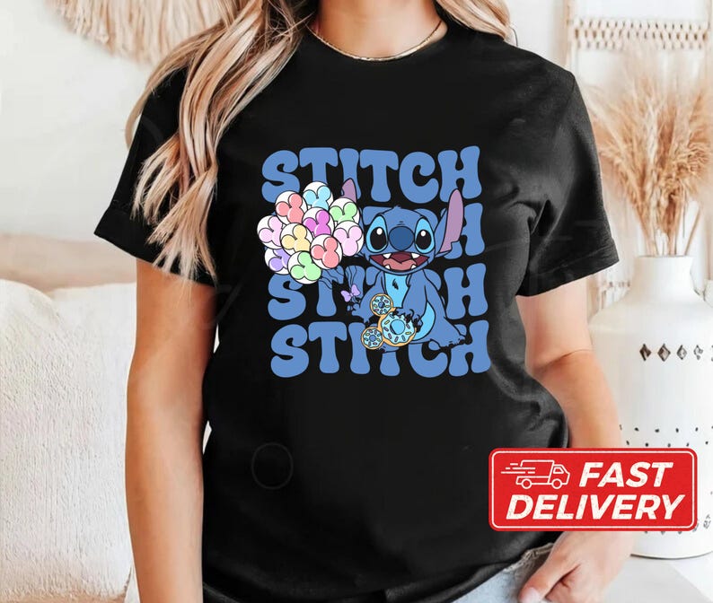 May include: Black t-shirt with a blue Stitch character holding a bunch of colorful balloons. The text "Stitch Stitch" is printed in white on the shirt.