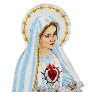 May include: Embroidered patch featuring a depiction of the Virgin Mary with a blue and white robe, a golden halo, and a red heart with thorns. The heart is surrounded by white lilies.