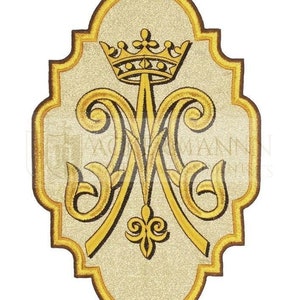 May include: A gold embroidered patch with a crown and the letters "M" and "A" intertwined. The patch is on a white background and has a scalloped border.