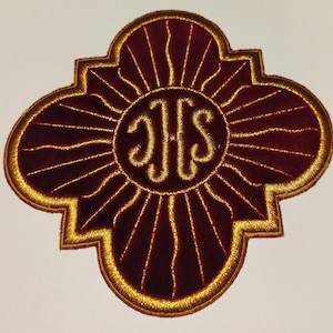 May include: A maroon velvet patch with a gold outline in the shape of a four-leaf clover. The center of the patch features a gold embroidered monogram of "JHS".