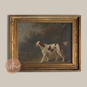 May include: A framed oil painting of a brown and white dog standing in a forest setting. The dog is looking to the left of the image. The painting is in a gold frame.