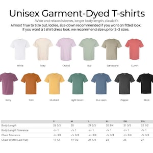 May include: A size chart for unisex garment-dyed t-shirts in a variety of colors, including white, ivory, orchid, bay, sandstone, cumin, berry, yarn, mustard, light green, blue jean, pepper, and black. The chart includes measurements for body length, body length tolerance, chest tolerance, and chest width (laid flat) in inches. The chart also includes sizes S, M, L, XL, 2XL, and 3XL.