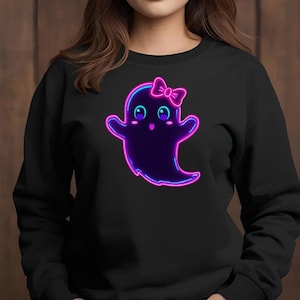 May include: Black sweatshirt featuring a cute ghost design. The ghost is purple with a neon pink and blue outline, a bow, and large eyes. The ghost is smiling and has its arms up.