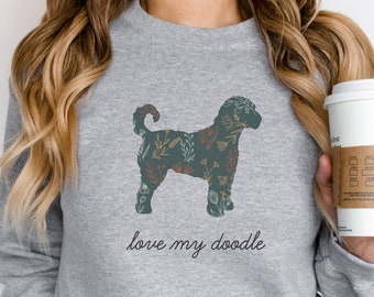 May include: Gray sweatshirt with a floral doodle dog silhouette and the text "love my doodle".