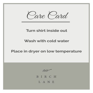 May include: Care card with instructions for washing and drying a shirt. The card says "Turn shirt inside out", "Wash with cold water", and "Place in dryer on low temperature". The card is from Birch Lane.