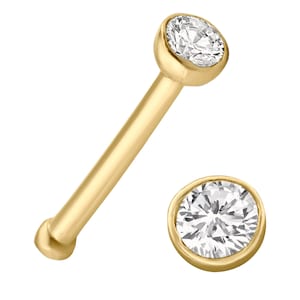 May include: A gold nose ring with a clear round gemstone. The ring is shown from two angles.