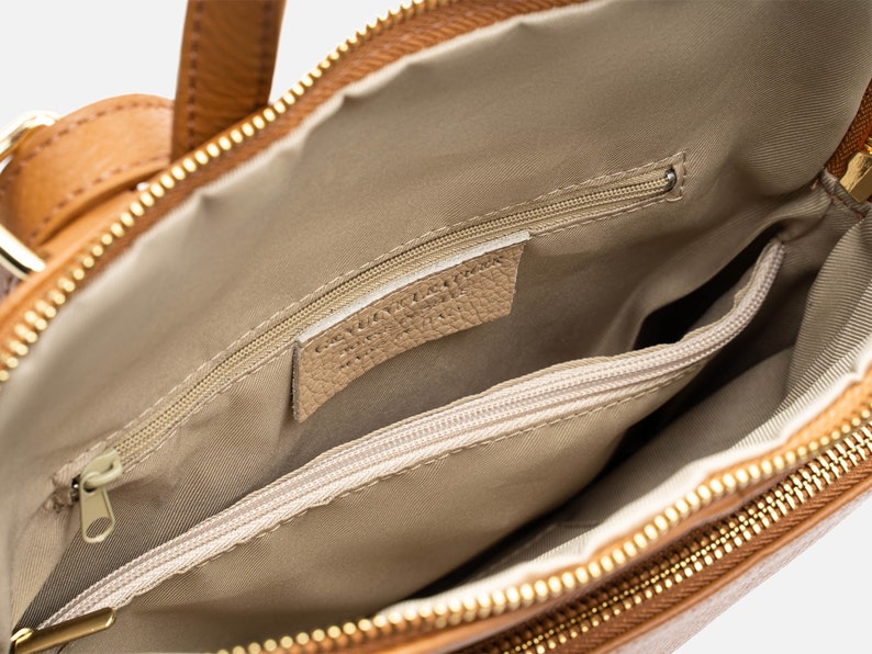 a brown purse with a zipper on the inside of it