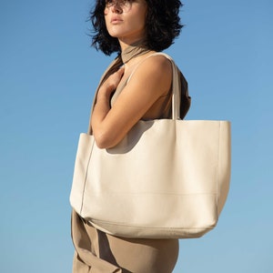 a woman holding a white bag in her hands