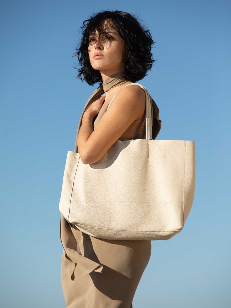 a woman holding a white bag in her hands