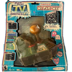 May include: A retro "Plug it in and Play TV Games" console featuring Ms. Pac-Man. The box is blue and green, with images of classic arcade games. The joystick is green and gold, and the box includes the text "5 Original Arcade Classics."