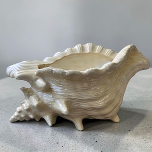 May include: A set of three ceramic mugs with a speckled, matte finish in cream, light grey, and dark grey. Each mug has a simple, minimalist design, ideal for coffee or tea.