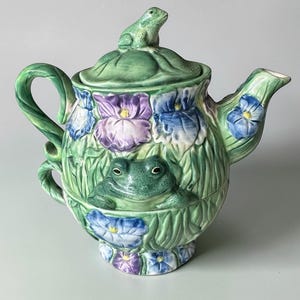 May include: A set of three ceramic mugs with a speckled, matte finish. Each mug features a different color: light blue, cream, and gray. The mugs have a simple, modern design and a comfortable handle.