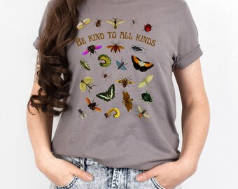 May include: A gray t-shirt with a graphic of various insects and the text "Be Kind To All Kinds".