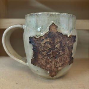 Handcrafted ceramic cream snowflake mug