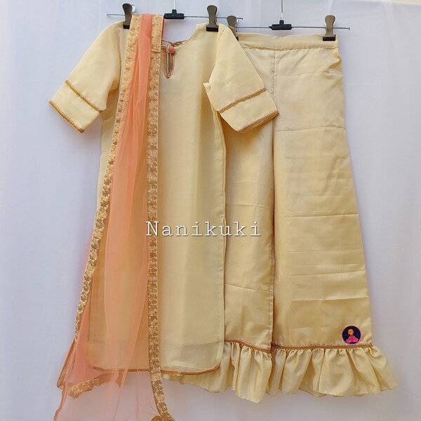 Ethnic kurta Palazzo set with a peach net dupatta for little girls.