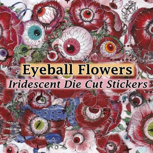 May include: Iridescent die-cut stickers featuring red flowers with eyeball centers. The text "Eyeball Flowers" and "Iridescent Die Cut Stickers" is printed on a pink banner.