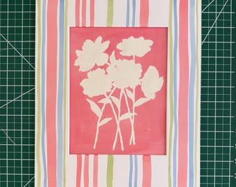 May include: A rectangular print featuring a central coral pink panel with a white silhouette of a floral bouquet. The border is decorated with vertical stripes in shades of coral, light blue, and lime green on a white background, measuring 10 inches.