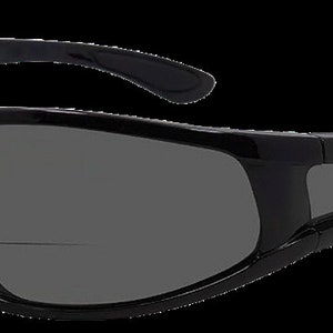 May include: Black wraparound sunglasses with a sporty design. The sunglasses have a dark gray lens and a black frame.