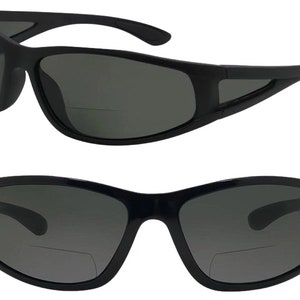 May include: Black sunglasses with a dark gray lens and a clear reading lens on the bottom. The sunglasses have a curved frame and a black plastic frame.