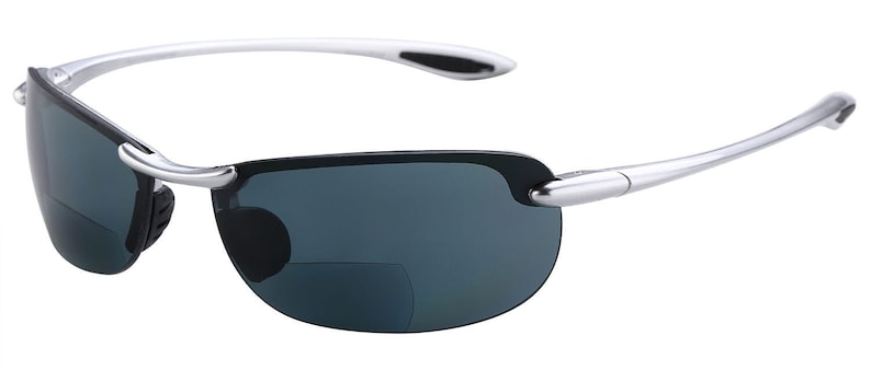 May include: Silver-framed sunglasses with dark gray lenses. The sunglasses have a clip-on feature for reading glasses.