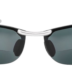 May include: A pair of black sunglasses with a silver frame. The sunglasses have a rimless design and dark gray lenses.