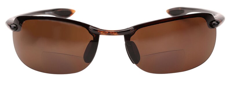 May include: Tortoise shell frame sunglasses with brown lenses. The sunglasses have a rimless design and are made of plastic.