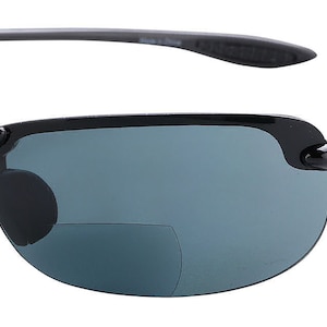 May include: Black sunglasses with a dark gray lens and a clip-on reading lens. The sunglasses have a black frame and a black temple.