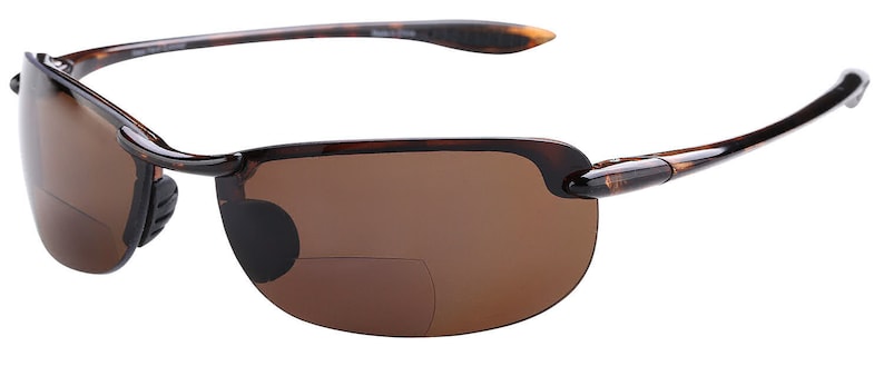 May include: Tortoise shell frame sunglasses with brown lenses. The sunglasses have a rimless design and a metal accent on the temples.