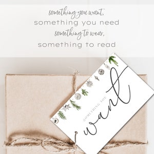 May include: A white gift tag with a handwritten "want" in black script. The tag is decorated with a border of silver and green ornaments and greenery. The text "SOMETHING YOU" is printed in black at the bottom of the tag.