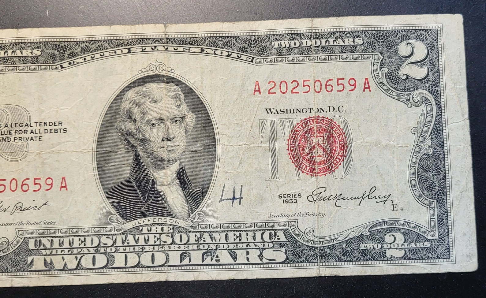 This is a 1953 Red Seal Two Dollar Bill. It is Not Centered and Has