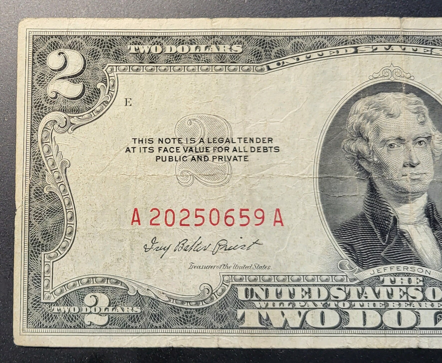 This is a 1953 Red Seal Two Dollar Bill. It is Not Centered and Has