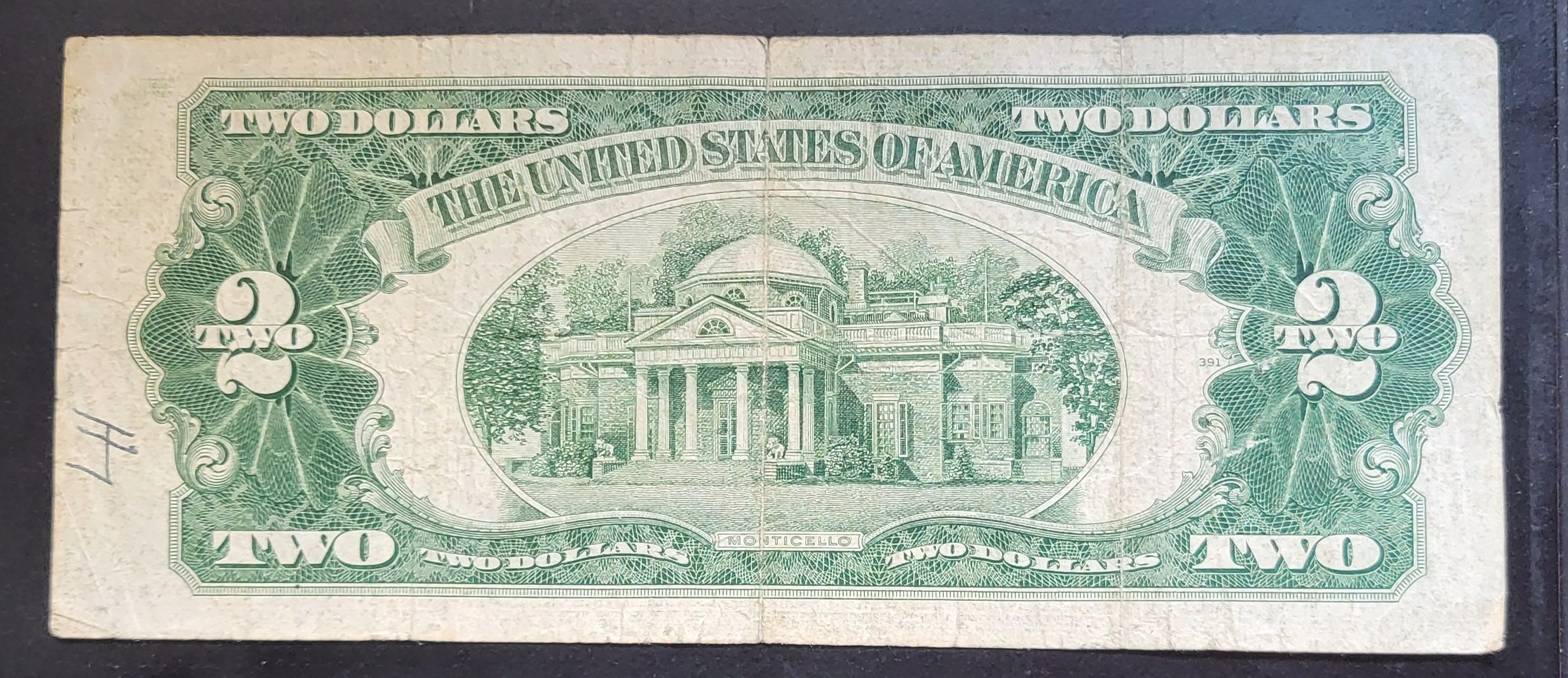 This is a 1953 Red Seal Two Dollar Bill. It is Not Centered and Has