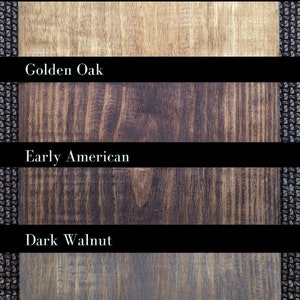 May include: Six wood stain samples showing different shades of brown. The stains are labeled from top to bottom: Weathered Summer Oak, Golden Oak, Early American, Dark Walnut, Western Oak, and Natural (sealed).
