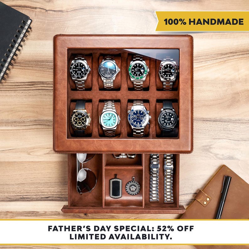 May include: A brown leather watch box with a glass lid containing eight wristwatches on cushions. The box features a pull-out drawer with compartments holding sunglasses, two metal pendants, and two metal watch bands. Text reads 100% HANDMADE.